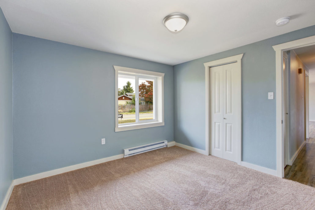 Light blue bedroom with closets